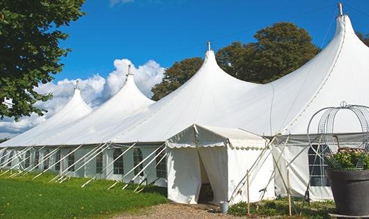 multiple portable restrooms in a row for added convenience at a concert venue in Brush Valley